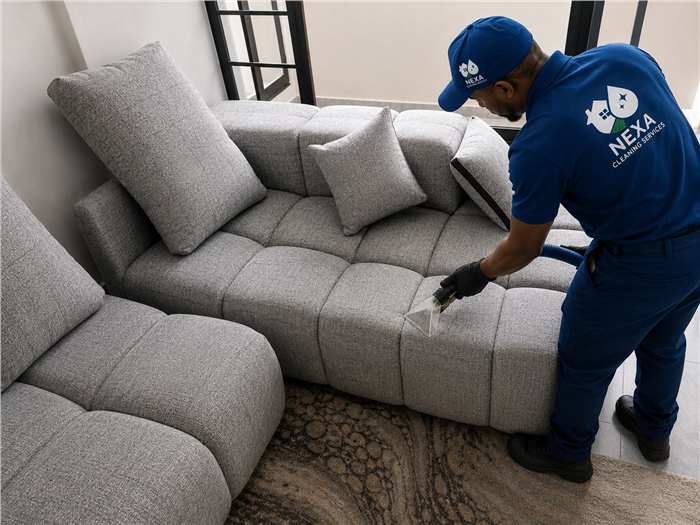 Nexa team performing sofa deep cleaning